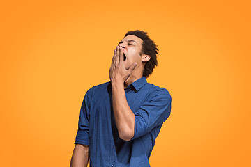 Image showing Beautiful bored man bored isolated on orange background