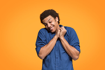 Image showing Handsome man looking suprised isolated on orange