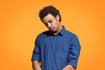 Image showing Beautiful bored man bored isolated on orange background