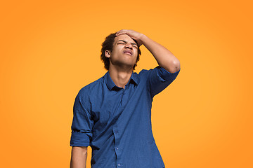 Image showing Beautiful bored man bored isolated on orange background