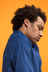 Image showing Beautiful bored afro man isolated on orange background