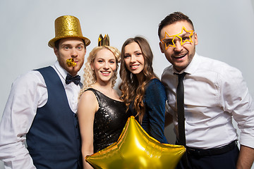 Image showing happy friends with golden party props posing