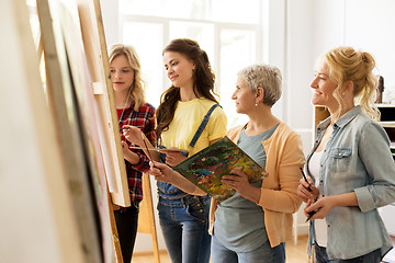 Image showing women with brushes painting at art school