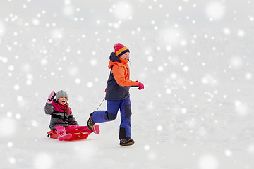 Image showing girls with sled having fun outdoors in winter