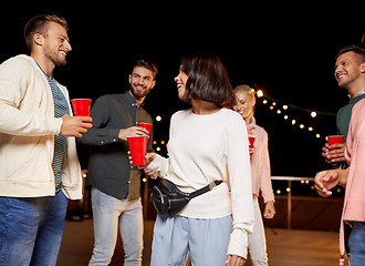 Image showing friends with drinks dancing at rooftop party