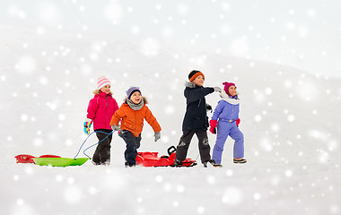 Image showing happy little kids with sleds in winter