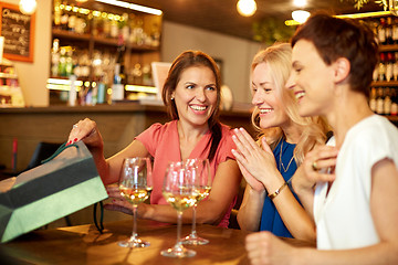 Image showing women with shopping bags at wine bar or restaurant
