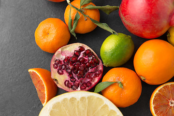 Image showing close up of citrus fruits on stone table