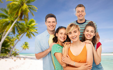 Image showing happy friends over tropical beach background