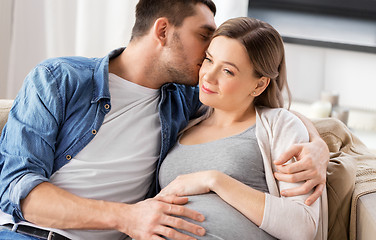 Image showing man hugging pregnant woman at home