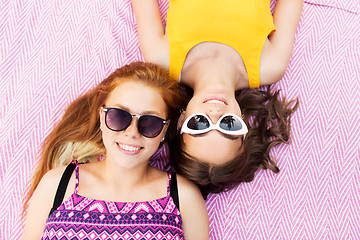 Image showing teenage girls in sunglasses on picnic blanket