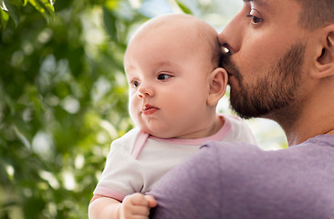 Image showing close up of father kissing little baby daughter