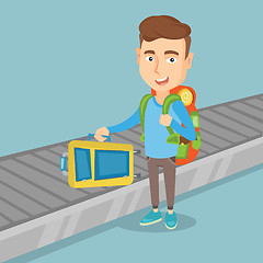 Image showing Man takes a suitcase on luggage conveyor belt.