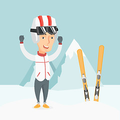 Image showing Cheerful skier standing with raised hands.