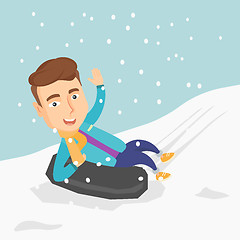 Image showing Man sledding on snow rubber tube in the mountains.