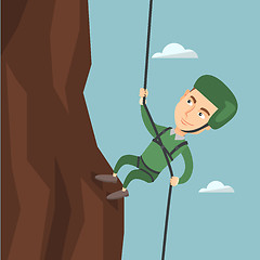 Image showing Man climbing a mountain with a rope.