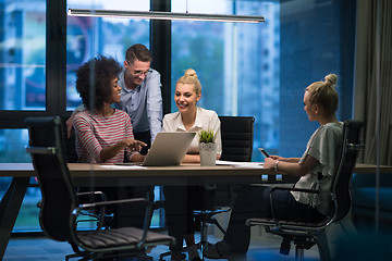 Image showing Multiethnic startup business team in night office