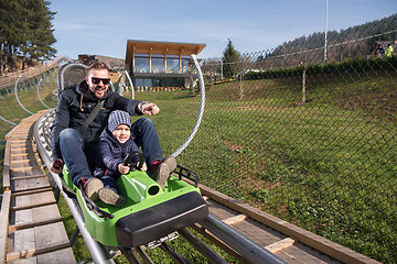 Image showing father and son enjoys driving on alpine coaster