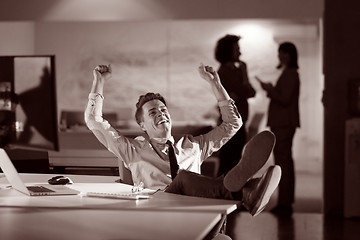 Image showing businessman sitting with legs on desk at office