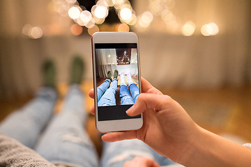 Image showing close up of couple taking foot photo by smartphone