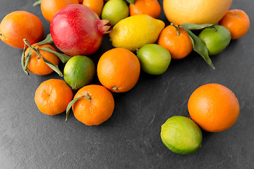 Image showing close up of citrus fruits on stone table