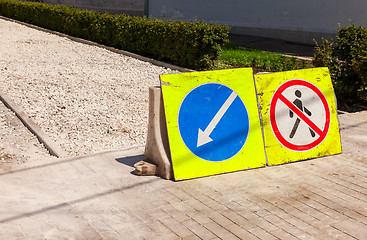 Image showing Road signs at the under construction sidewalk in summer day