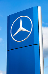 Image showing Official dealership sign of Mercedes-Benz over blue sky