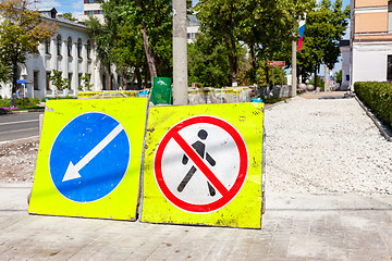 Image showing Road signs at the under construction sidewalk in summer day