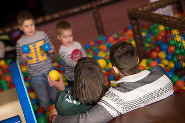 Image showing young parents with kids in a children\'s playroom