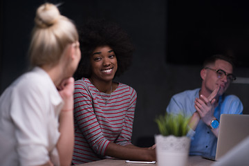 Image showing Multiethnic startup business team in night office