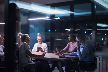 Image showing Multiethnic startup business team in night office