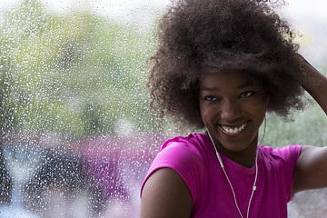 Image showing portrait of young afro american woman in gym while listening mus