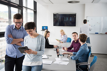 Image showing Two Business People Working With Tablet in office