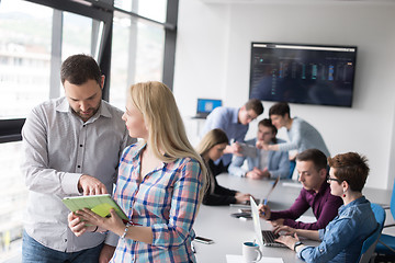 Image showing Two Business People Working With Tablet in office