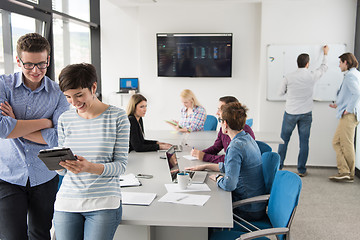 Image showing Two Business People Working With Tablet in office