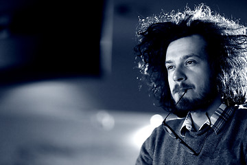 Image showing man working on computer in dark office