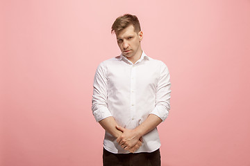 Image showing Let me think. Doubtful pensive man with thoughtful expression making choice against pink background