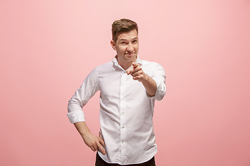 Image showing The happy business man point you and want you, half length closeup portrait on pink background.