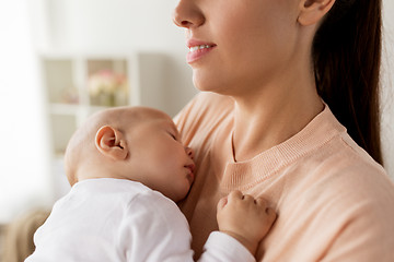 Image showing close up of mother holding sleeping baby