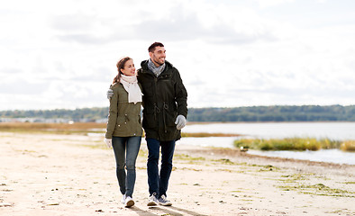 Image showing couple walking along autumn beach