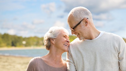 Image showing happy senior couple over beach background