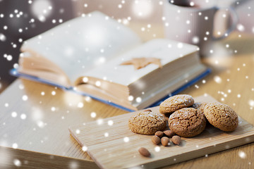 Image showing oatmeal cookies, almonds and book on table at home