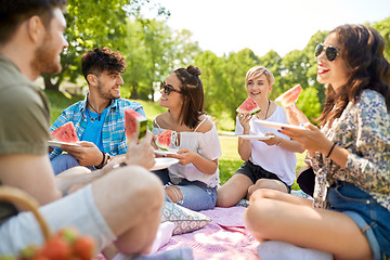 Image showing happy friends eating watermelon at summer picnic