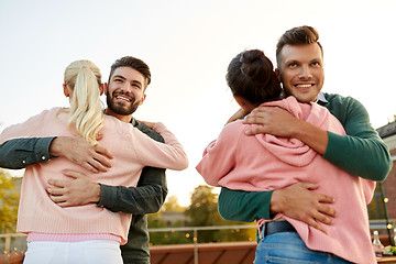 Image showing couples or friends hugging at on rooftop party