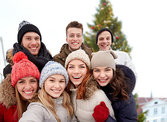 Image showing happy friends over christmas tree in old tallinn