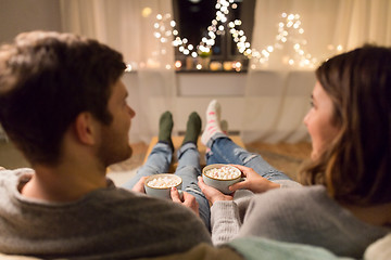 Image showing close up of couple drinking hot chocolate at home