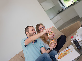 Image showing couple eating pizza in their luxury home villa