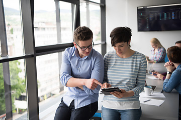 Image showing Two Business People Working With Tablet in office