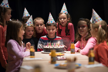 Image showing The young boy joyfully celebrating his birthday