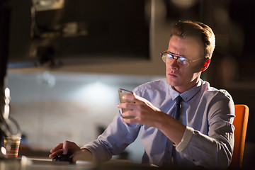 Image showing man using mobile phone in dark office